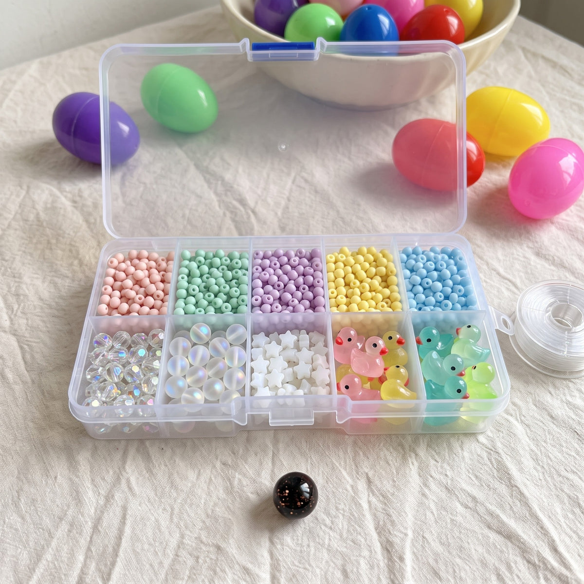 Clear bead box with beads and ducks sorted by colour
