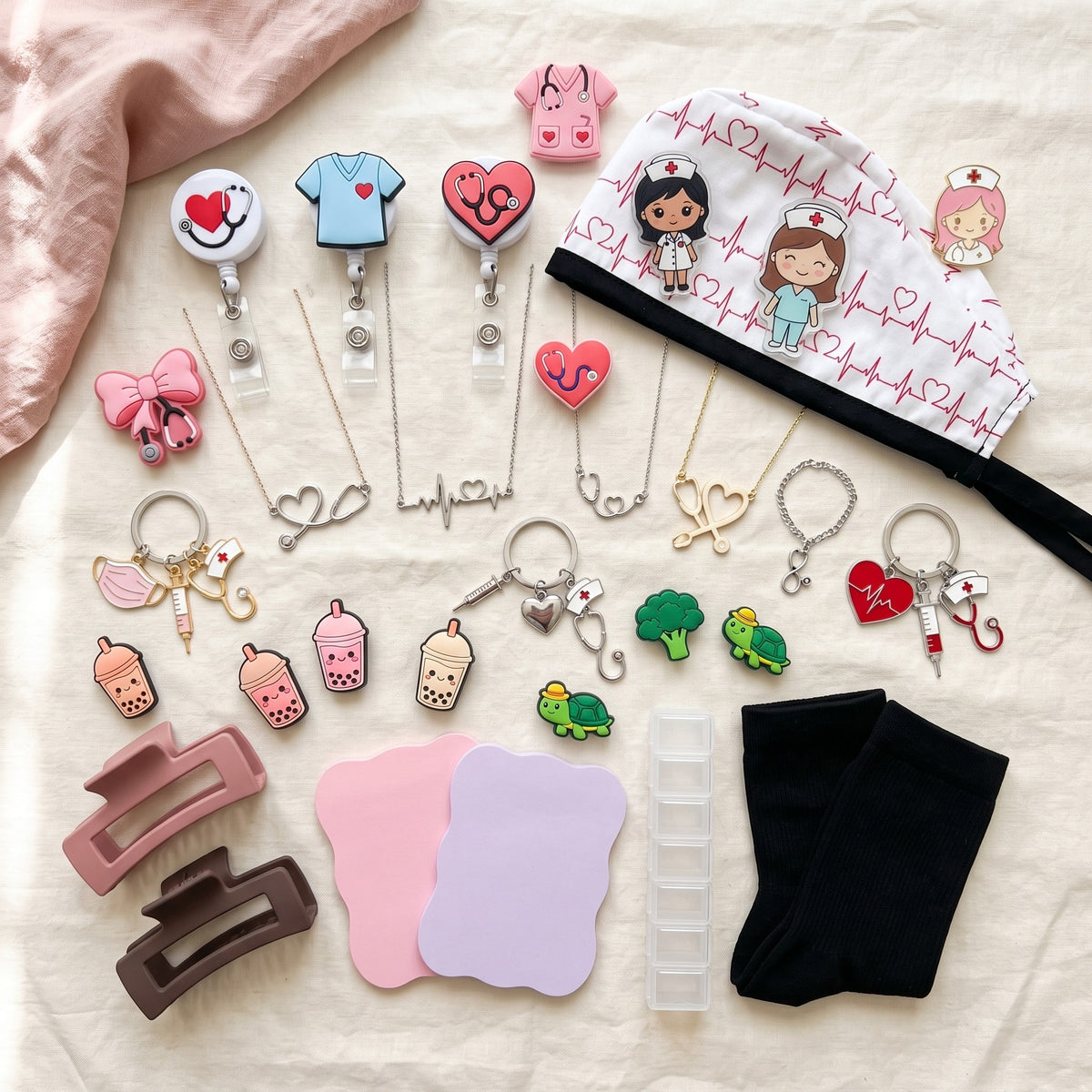 Everything in a Triple Scoop laid out: scrub cap, socks, pill organizer, sticky notes, badge reels, jewelry and charms