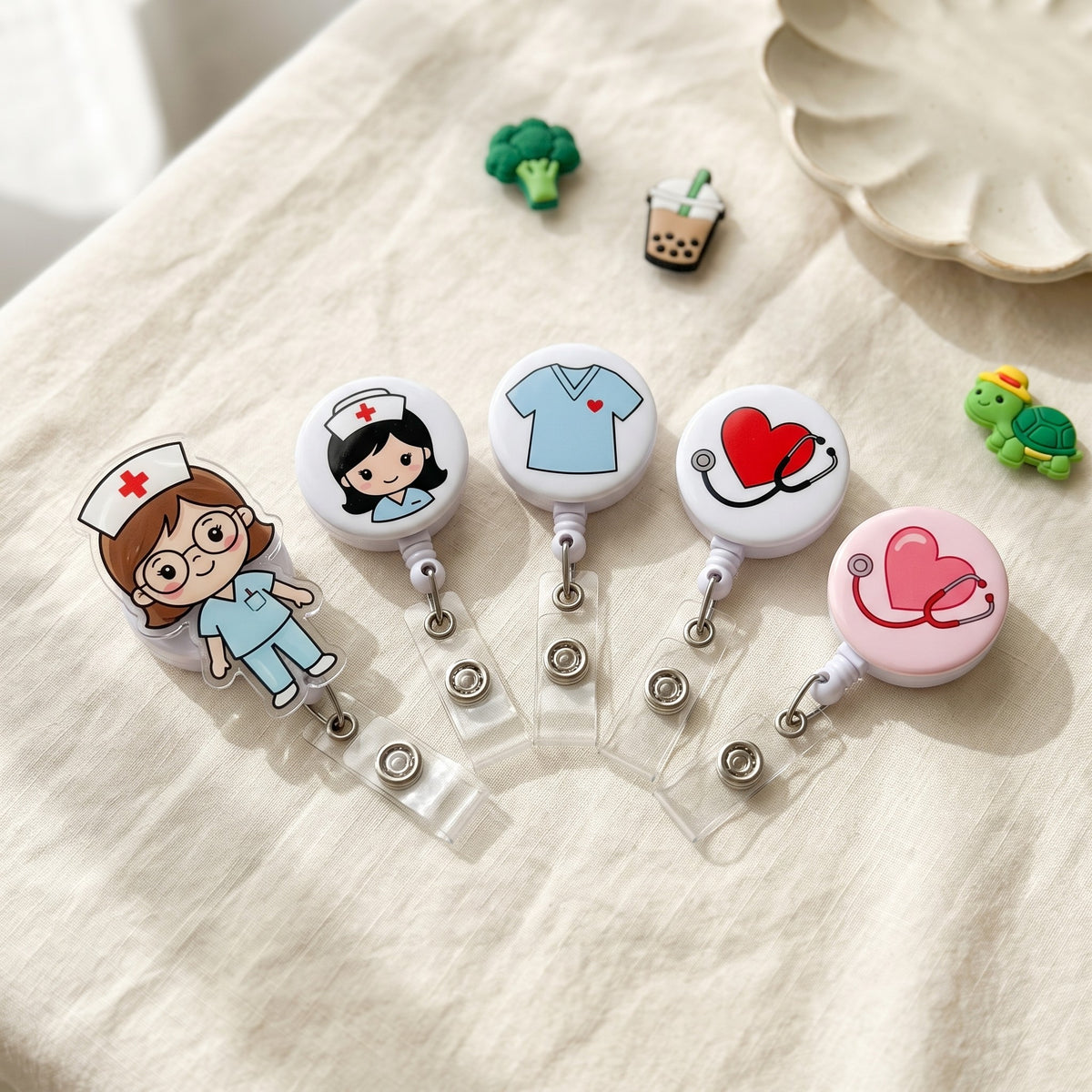 Five retractable badge reels with hearts, stethoscopes, scrubs and little nurses